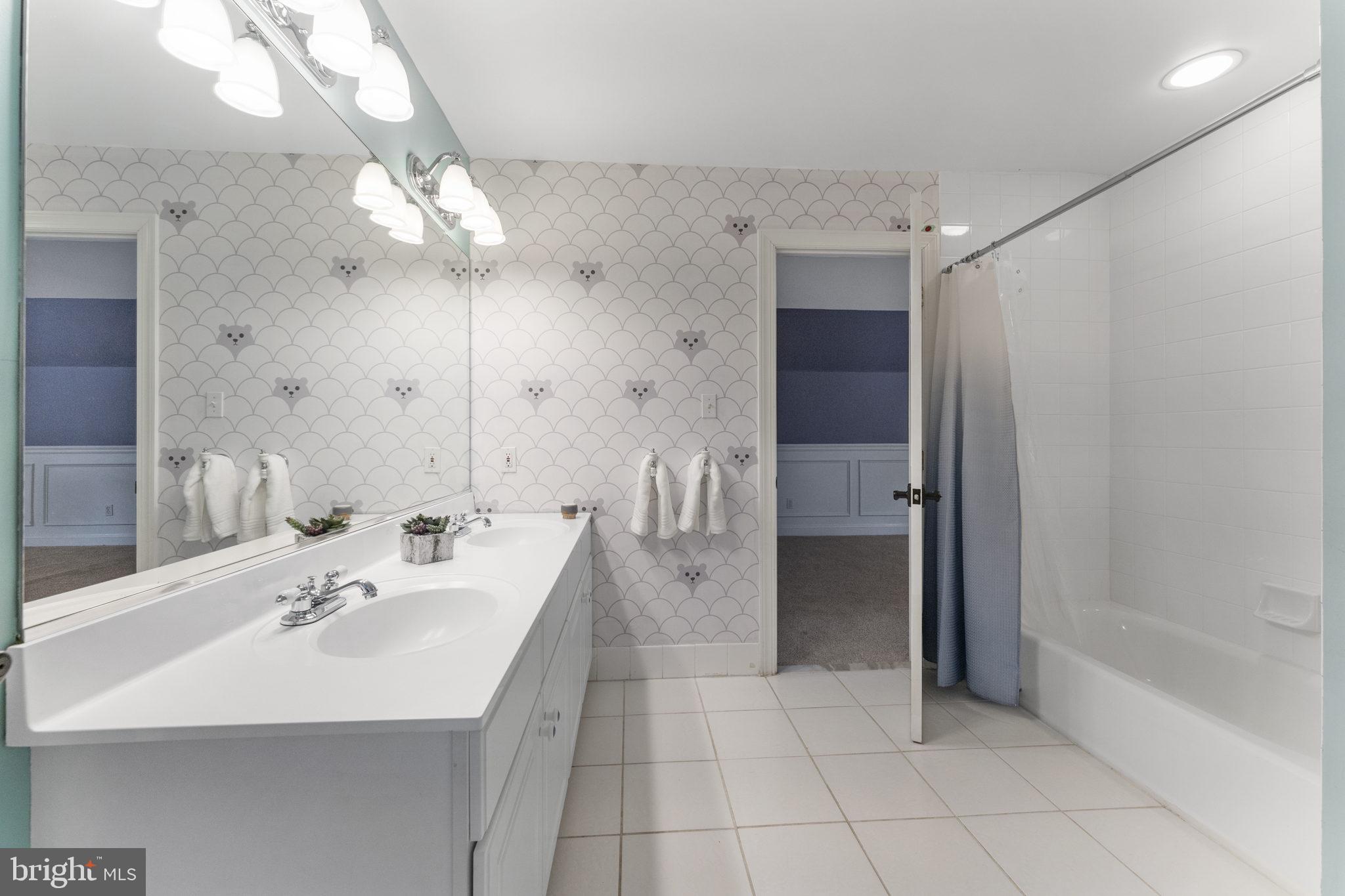 1122 King Of Prussia Road Wayne, PA 19087 - Photo 24 of 33 a spacious bathroom with a sink a large mirror and shower