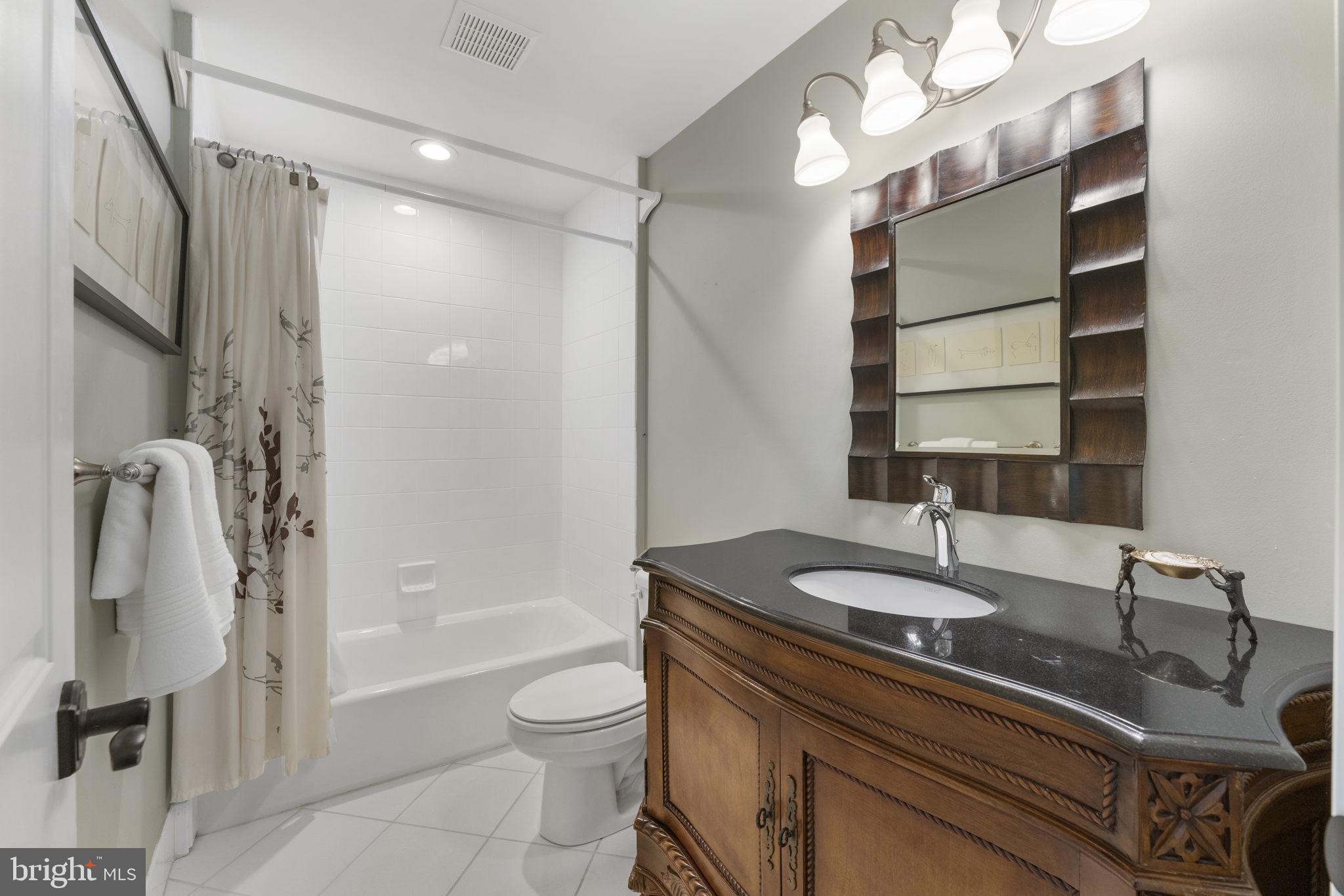 1122 King Of Prussia Road Wayne, PA 19087 - Photo 26 of 33 a bathroom with a granite countertop sink a toilet and shower