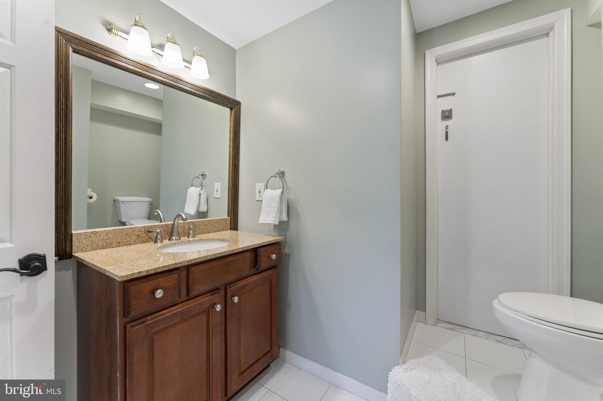 1122 King Of Prussia Road Wayne, PA 19087 - Photo 30 of 33 a bathroom with a toilet a sink and mirror
