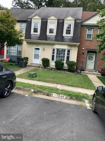 a view of a car parked in front of a brick house