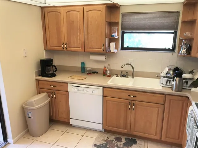 a utility room with sink dryer and washer