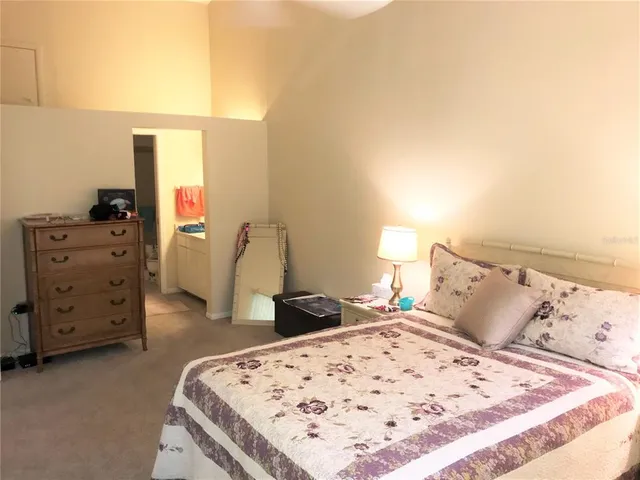 a bedroom with a bed and dresser