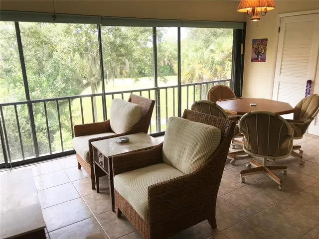 a living room with furniture and large windows