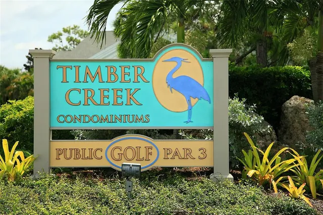 a view of a yard with plants and a fountain