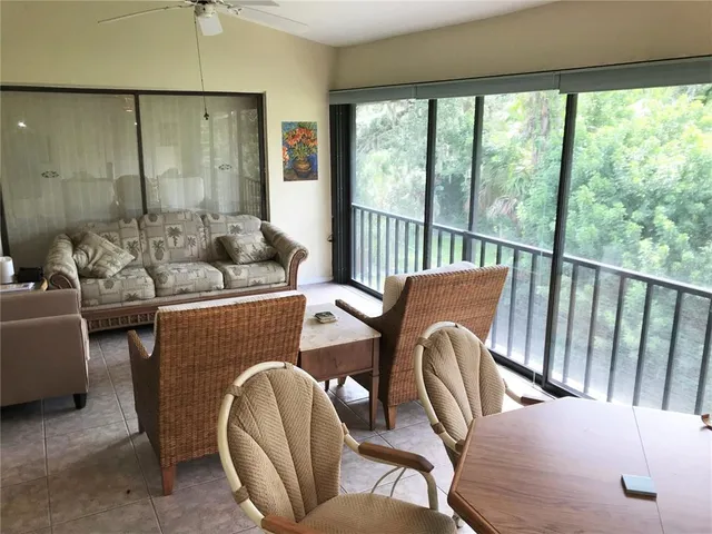 a balcony with furniture and a potted plant