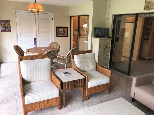 a living room with furniture rug and lamp