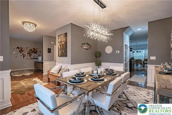 a kitchen with granite countertop a table chairs and a wooden floor