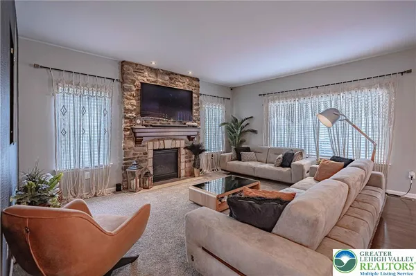 a kitchen with granite countertop a stove a sink dishwasher a dining table and chairs with wooden floor