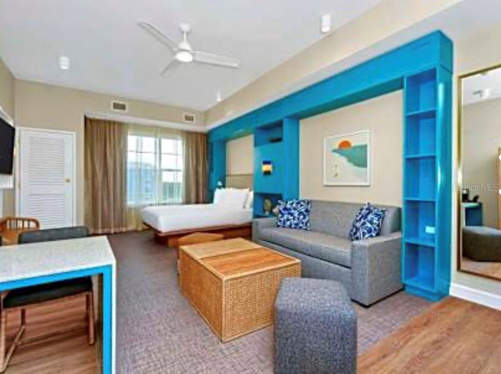 3151 Sunset Walk Drive, Unit 411 Kissimmee, FL 34747 - Photo 12 of 23 a living room with furniture and a flat screen tv