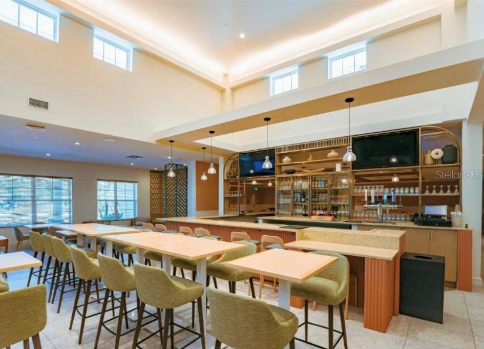 3151 Sunset Walk Drive, Unit 411 Kissimmee, FL 34747 - Photo 15 of 23 a kitchen with stainless steel appliances kitchen island granite countertop a table and chairs