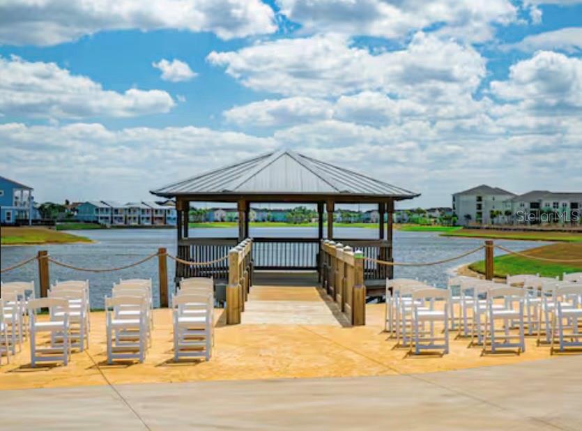3151 Sunset Walk Drive, Unit 411 Kissimmee, FL 34747 - Photo 16 of 23 a view of a swimming pool with lawn chairs under an umbrella