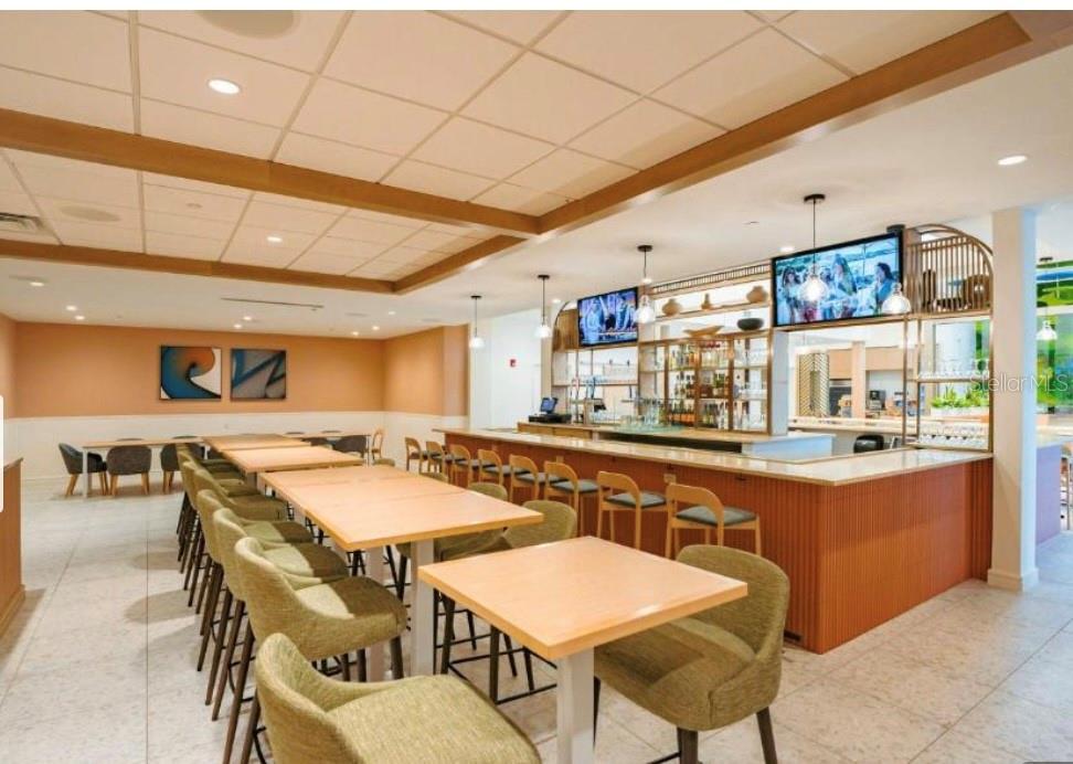 3151 Sunset Walk Drive, Unit 411 Kissimmee, FL 34747 - Photo 18 of 23 a kitchen with a table chairs and wooden floor