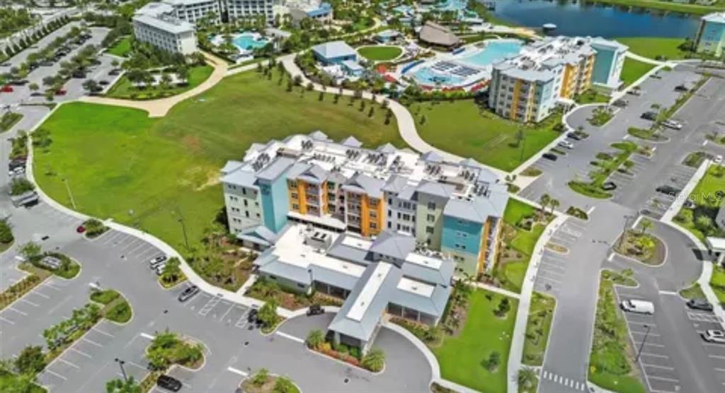 3151 Sunset Walk Drive, Unit 411 Kissimmee, FL 34747 - Photo 6 of 23 an aerial view of a house with a swimming pool a yard and mountain view in back