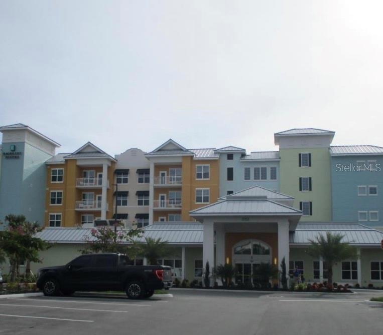 3151 Sunset Walk Drive, Unit 411 Kissimmee, FL 34747 - Photo 9 of 23 a front view of residential building and car parked