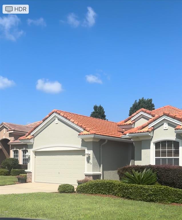 994 West Silver Meadow Loop Hernando, FL 34442 - Photo 11 of 11 a front view of a house with a garden