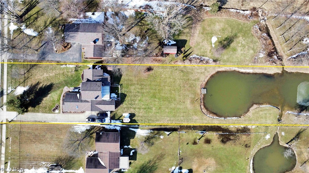 563 North Carpenter Road Brunswick, OH 44212 - Photo 39 of 45 Aerial perspective of suburban area with property parcel outlined and a large body of water
