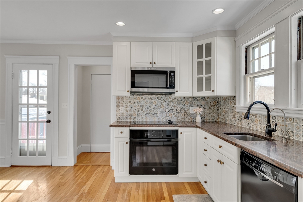 10 Dexter Road Lexington, MA 02420 - Photo 19 of 35 a kitchen with granite countertop a stove a sink and a microwave