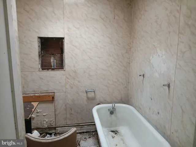 a bathroom with a toilet a sink and bathtub