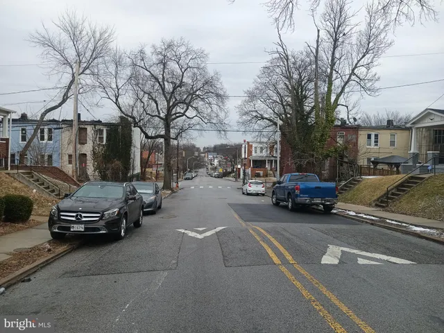 a view of a cars parked on the side of a street