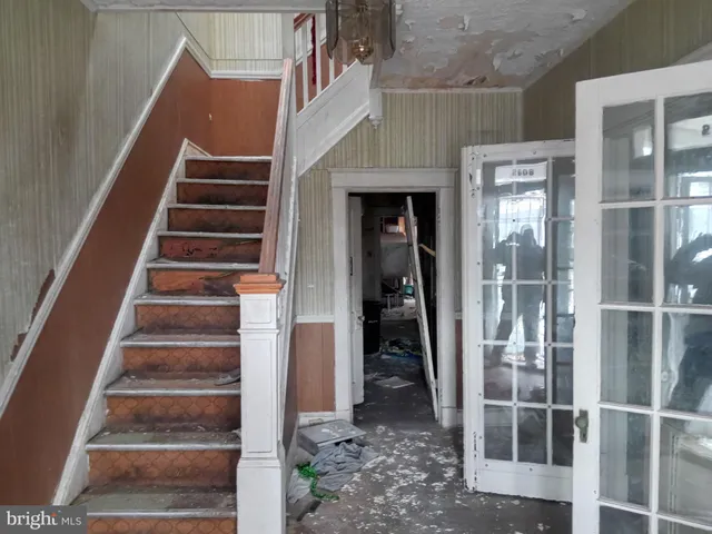 a view of entryway and hall with wooden floor