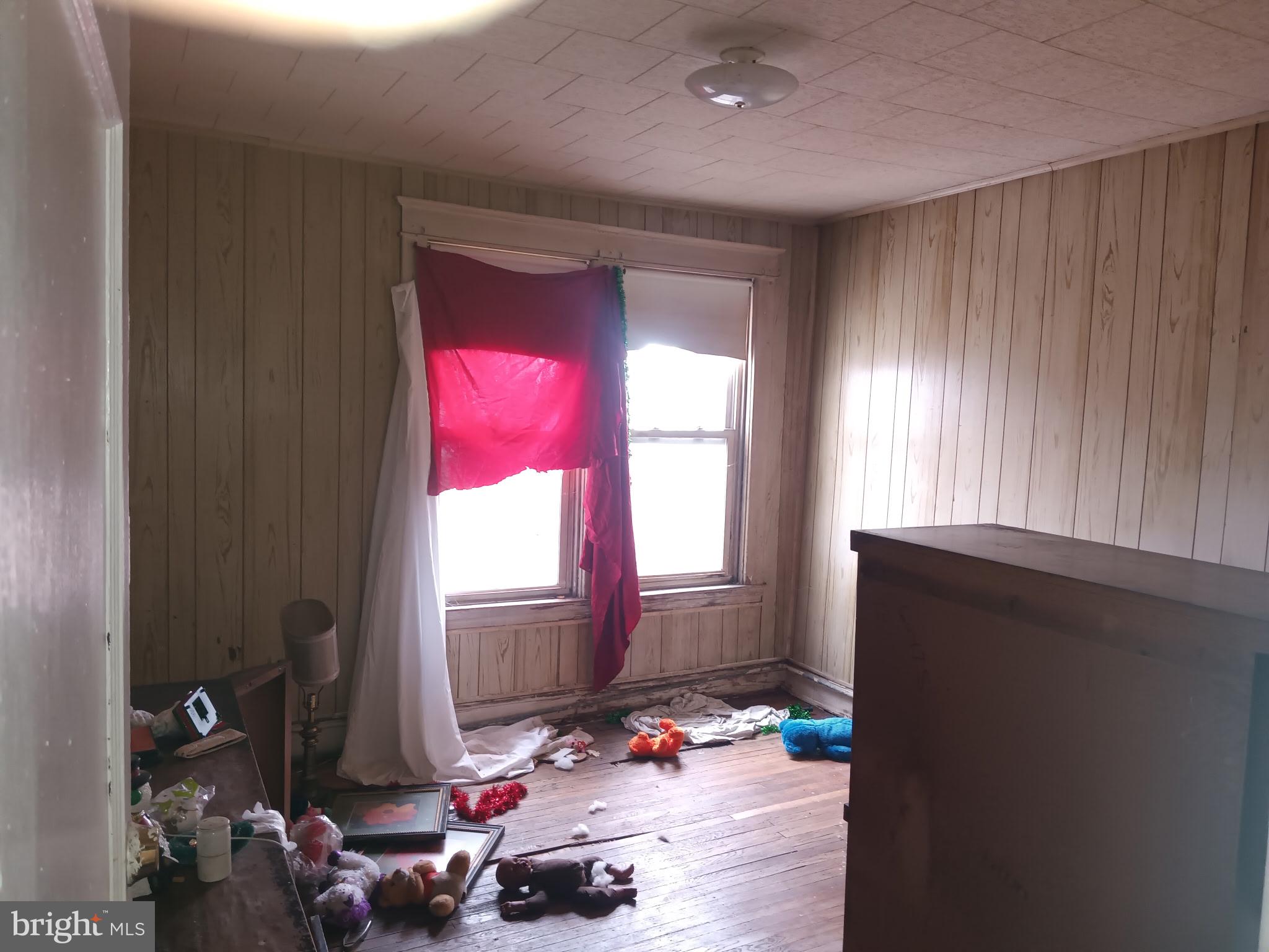 2908 Baker Street Baltimore, MD 21216 - Photo 10 of 15 a bedroom with furniture and a window