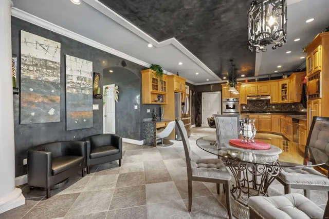 a living room with furniture and a chandelier