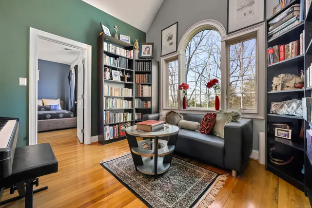 a living room with fireplace furniture and a book shelf