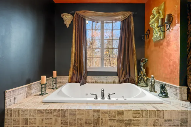 a bath tub sitting next to a bathroom and sink