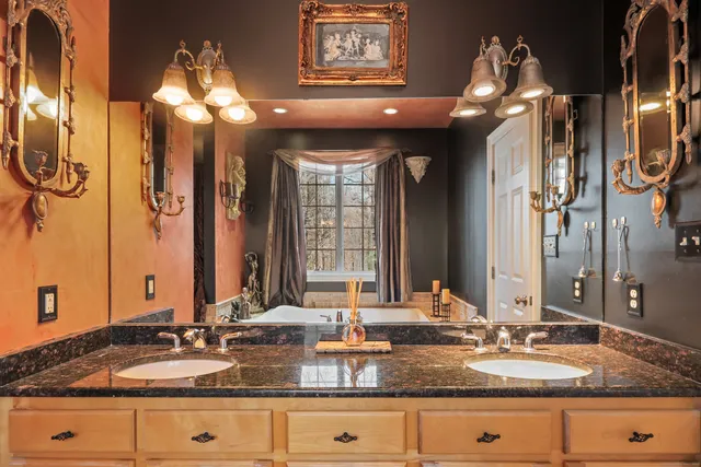 a bathroom with sinks granite countertop double vanity and a mirror