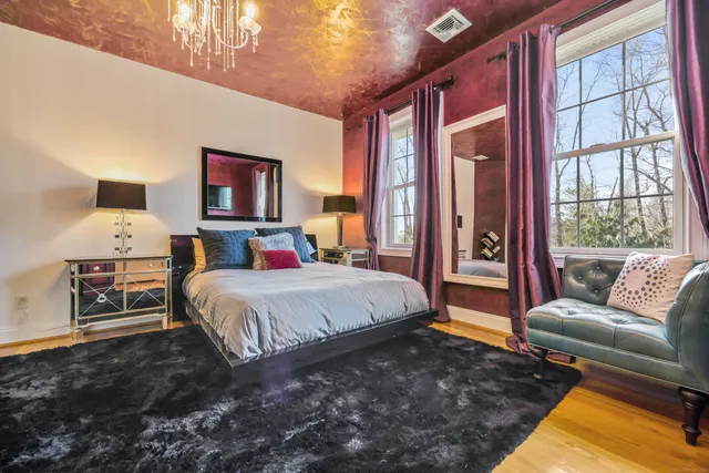 a bedroom with a bed couch and window