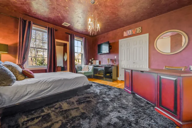 a bed room with a bed and a television