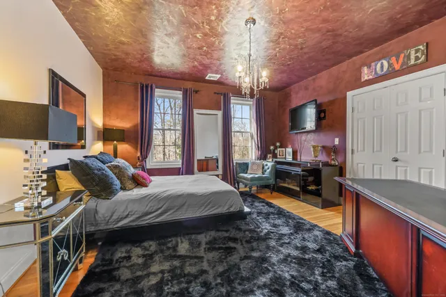 a bed room with a bed window and a television