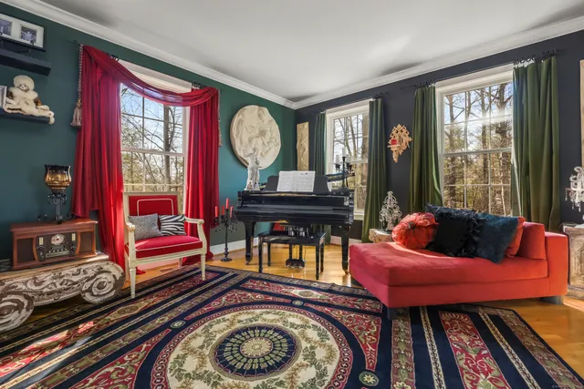 a living room with furniture a window and wooden floor