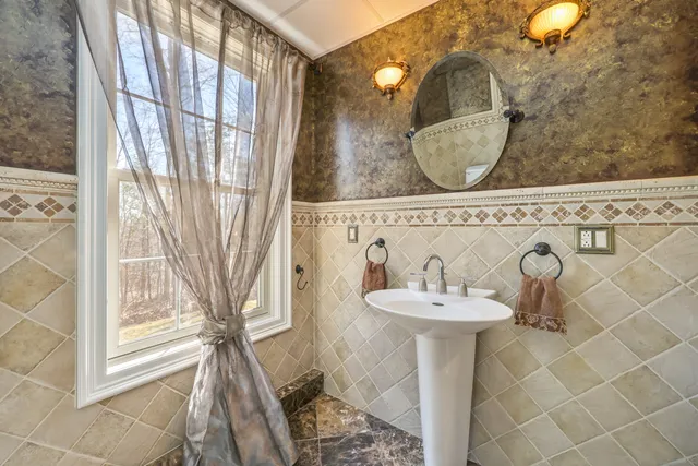 a bathroom with a sink a mirror and a shower