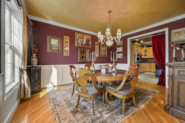 a view of a dining room with furniture and a chandelier