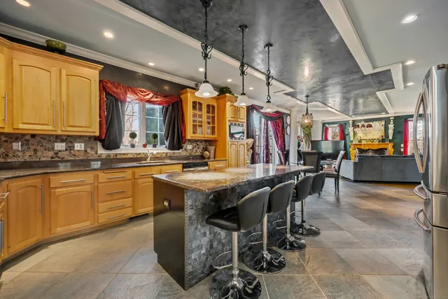 a kitchen with lots of wooden cabinets appliances and furniture