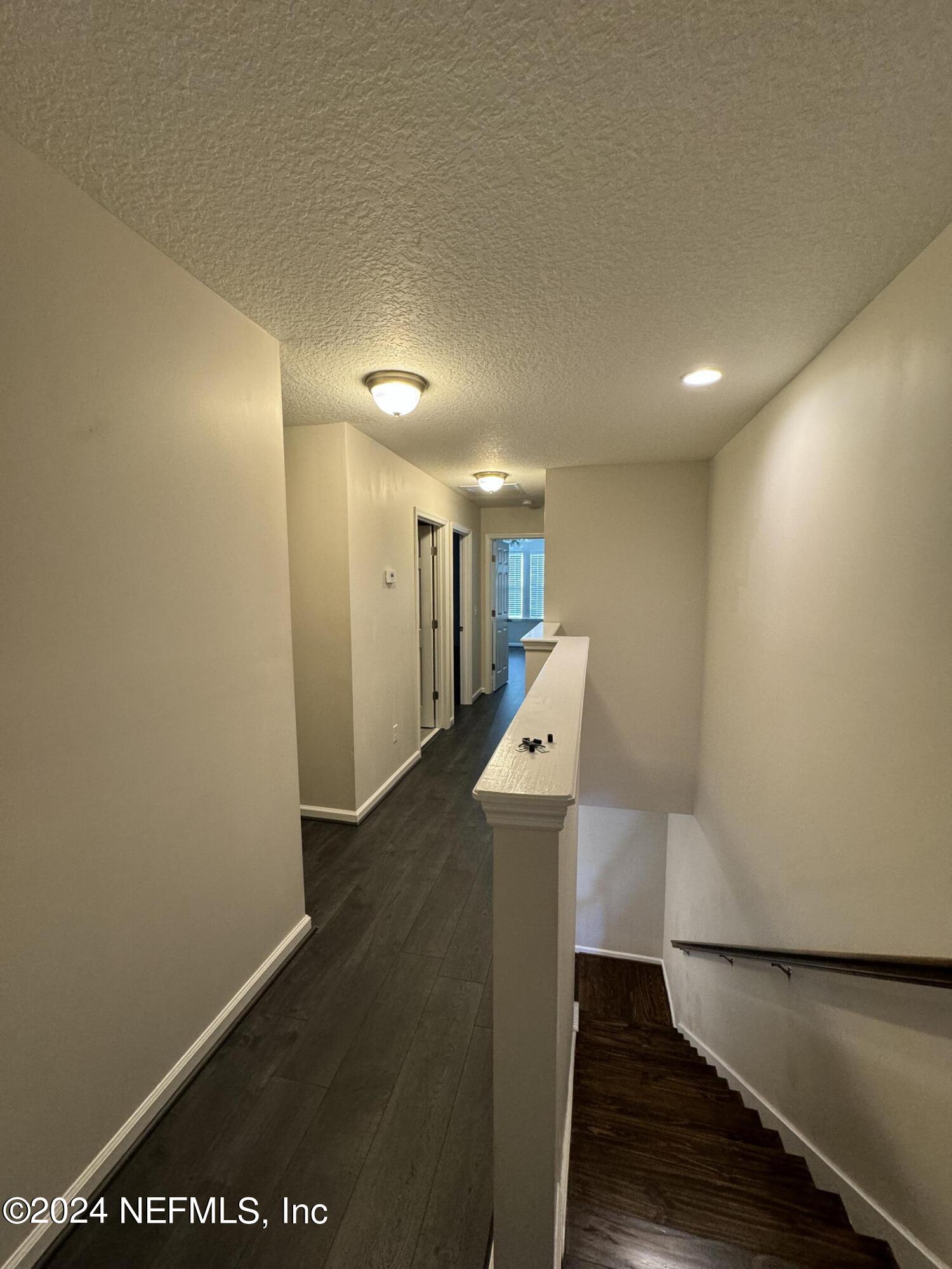 144 Nelson Lane St. Johns, FL 32259 - Photo 13 of 18 a view of a hallway with wooden floor
