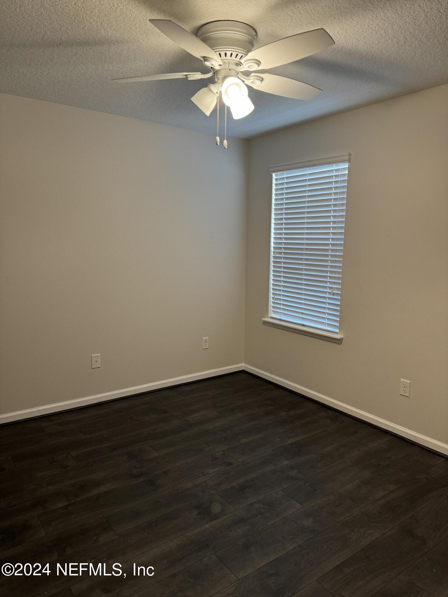 144 Nelson Lane St. Johns, FL 32259 - Photo 16 of 18 a view of an empty room with wooden floor and a window