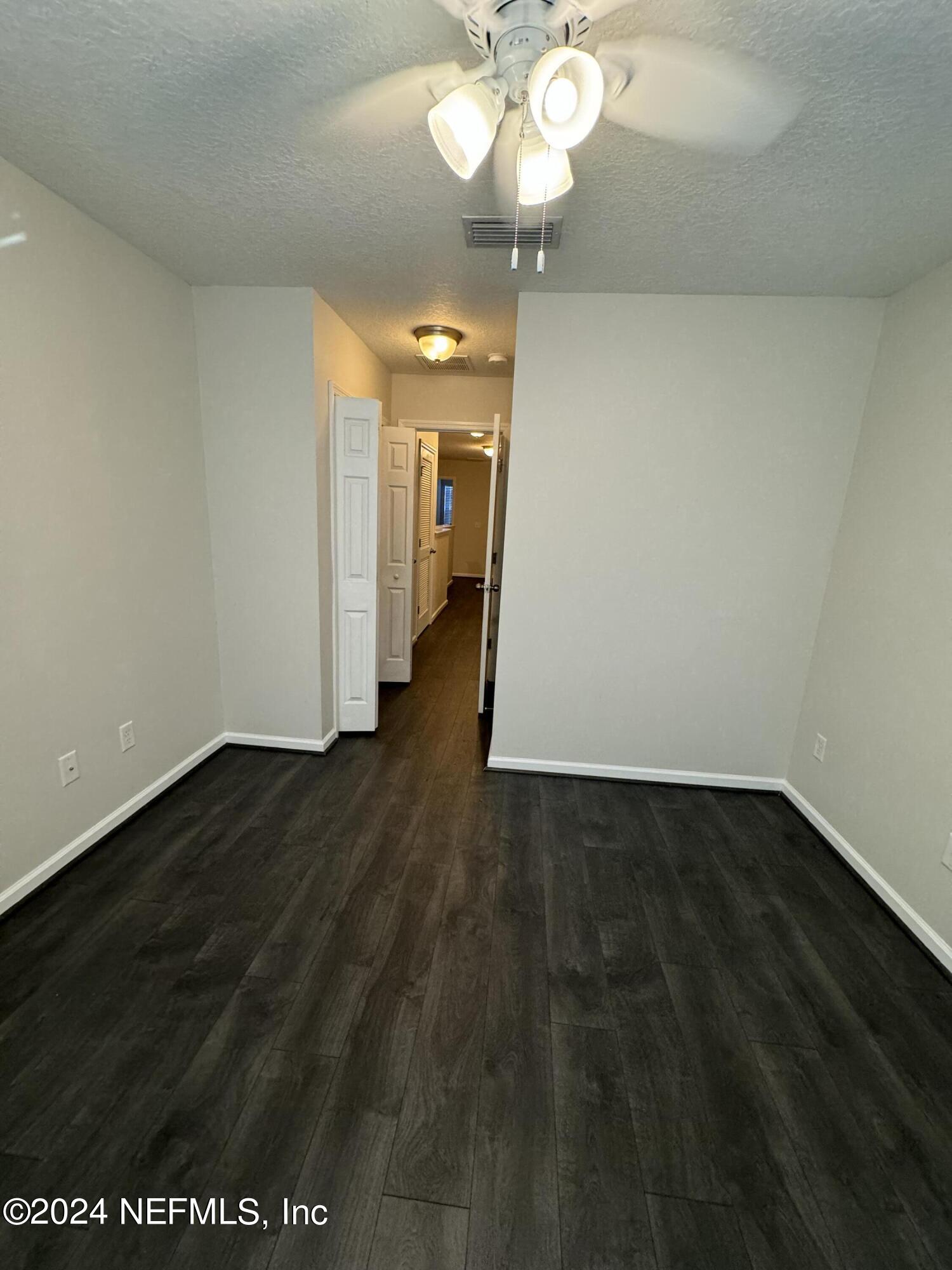 144 Nelson Lane St. Johns, FL 32259 - Photo 17 of 18 a view of a room with wooden floor and a ceiling fan
