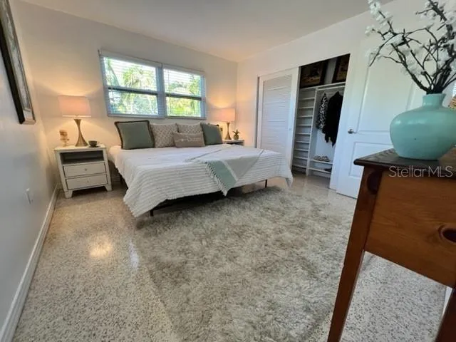 a bedroom with a bed and window