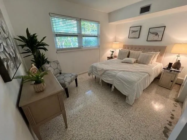 a bedroom with a bed and window