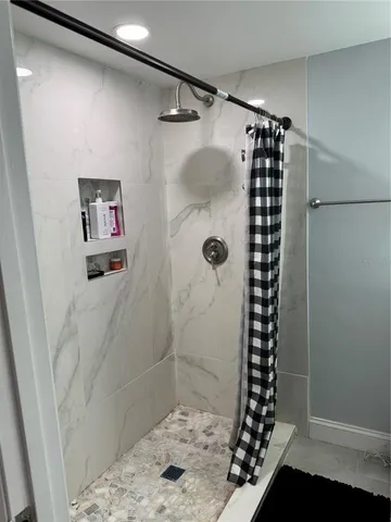 a bathroom with a shower and a sink