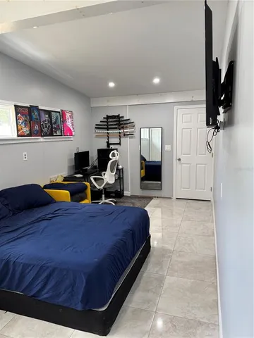 a bed room with a bed and a television