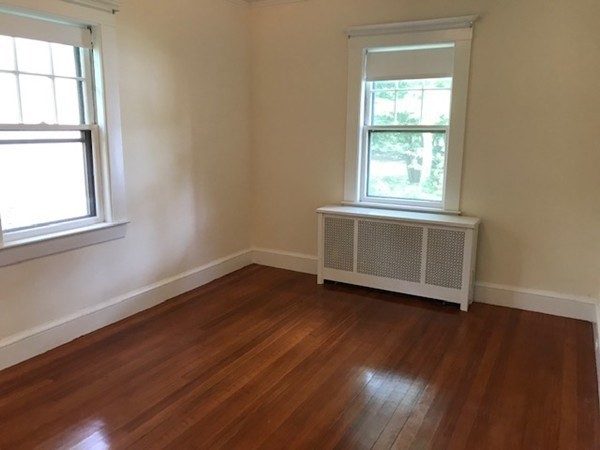 19 Homestead Road, Unit 1 Wellesley, MA 02482 - Photo 13 of 32 an empty room with wooden floor and windows