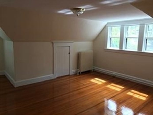 19 Homestead Road, Unit 1 Wellesley, MA 02482 - Photo 17 of 32 an empty room with wooden floor and windows