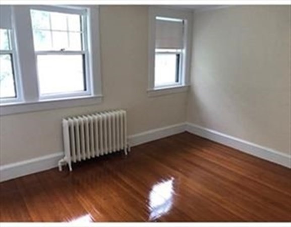 19 Homestead Road, Unit 1 Wellesley, MA 02482 - Photo 18 of 32 an empty room with wooden floor and windows
