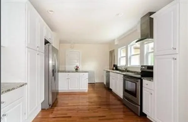 a kitchen with stainless steel appliances granite countertop a stove and a refrigerator