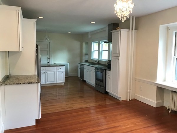 19 Homestead Road, Unit 1 Wellesley, MA 02482 - Photo 9 of 32 a kitchen with granite countertop a stove and a refrigerator