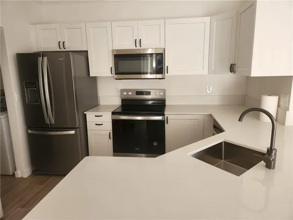 a kitchen with a refrigerator stove and microwave