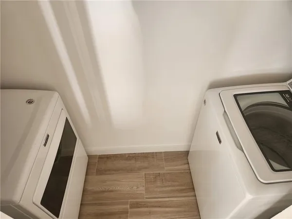 a room with a sink a window and a glass door